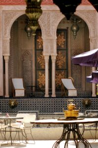 Stunning Moroccan courtyard with intricate designs and relaxing chairs in Marrakech.