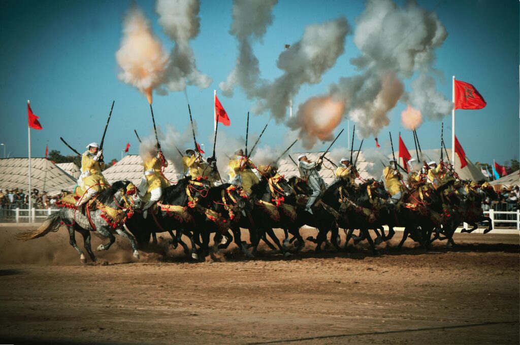 Moroccan horsemen perform a Tbourida at El Jadida's festival, showcasing tradition and skill.