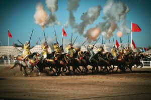 Moroccan horsemen perform a Tbourida at El Jadida's festival, showcasing tradition and skill.